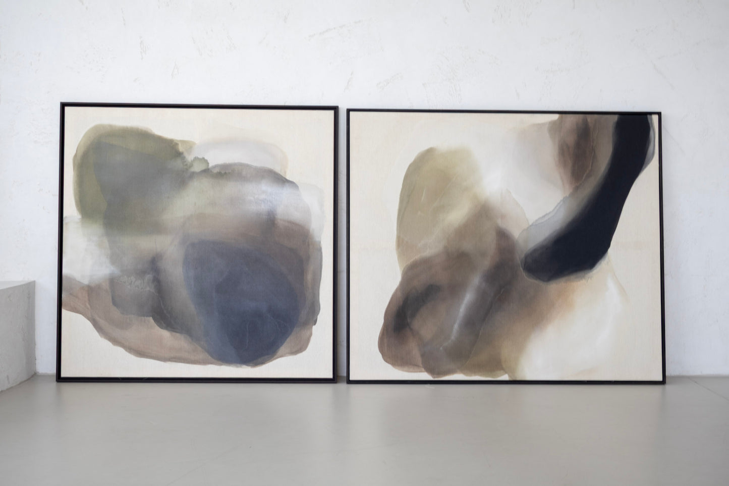 Abstract painting “Edge of Day” shown alongside another artwork from the Before the Light Touches series, framed in dark wood, displayed in studio interior.